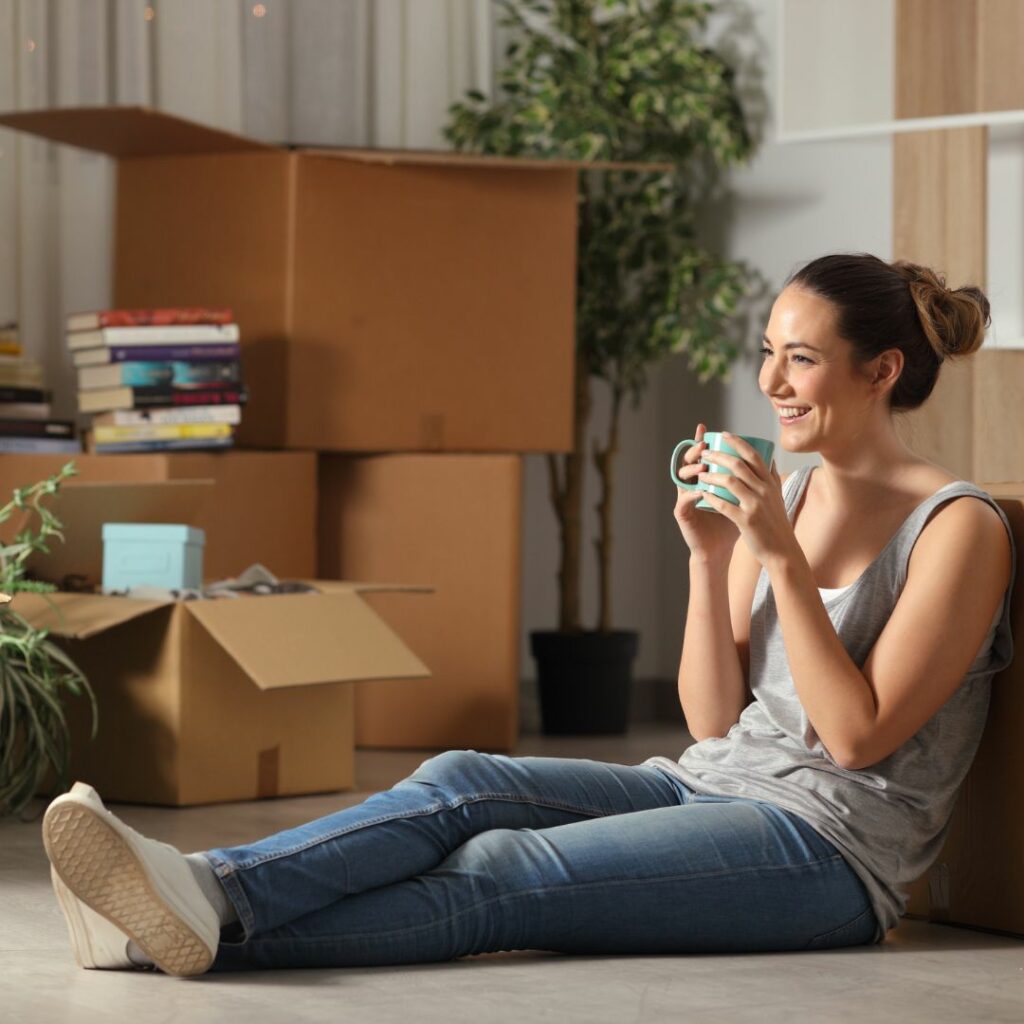 relaxed woman sitting among moving boxes