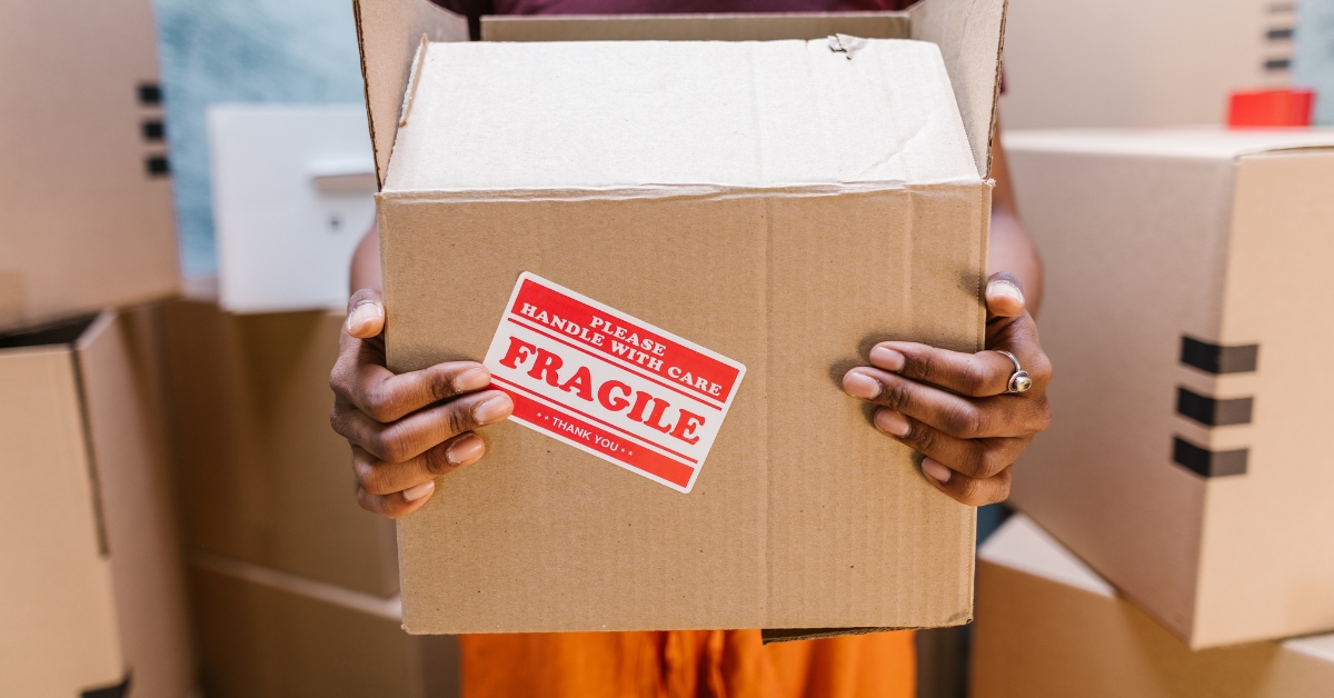 woman holding a Fragile moving box