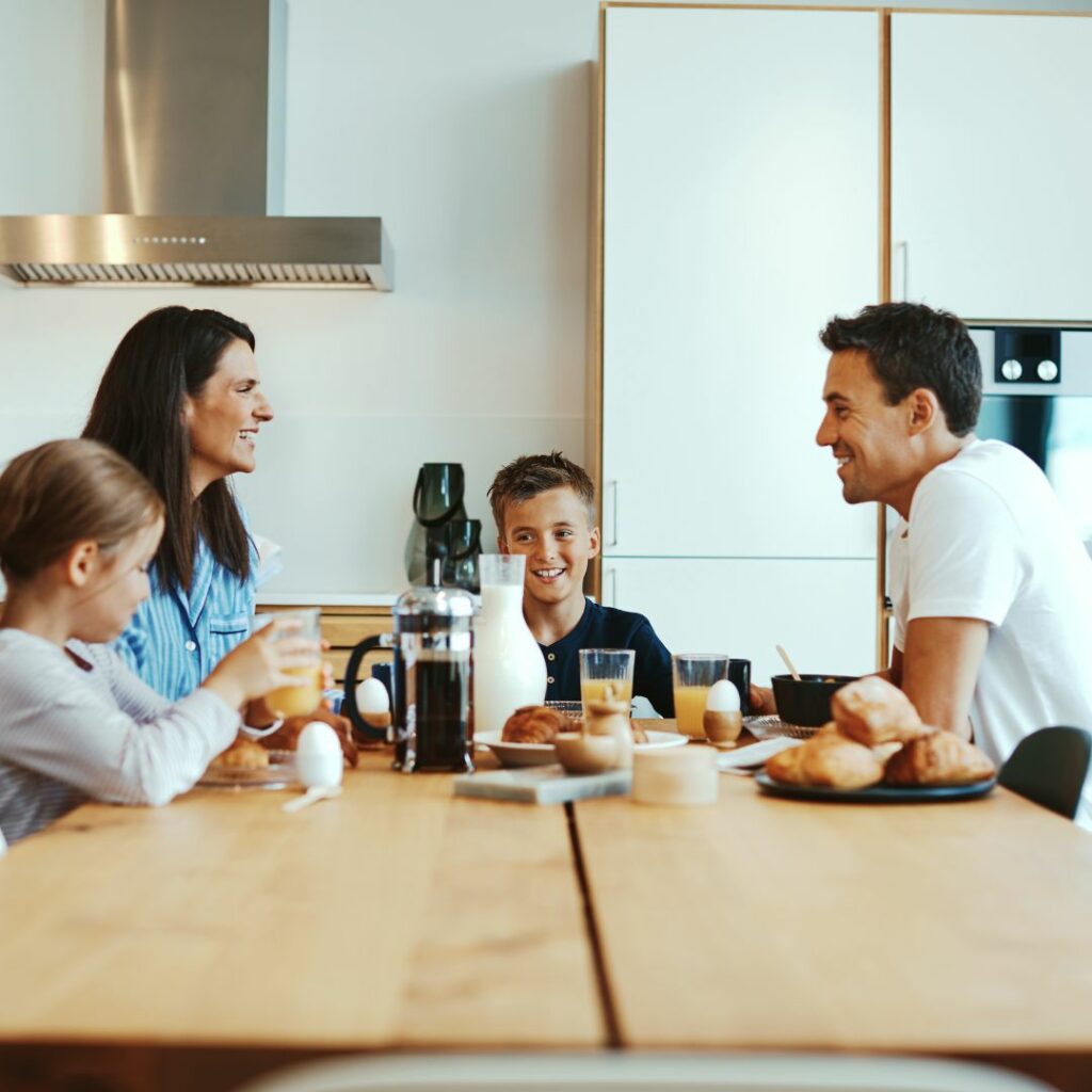Family talking while eating breakfast
