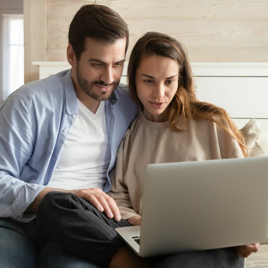 Couple on laptop house hunting