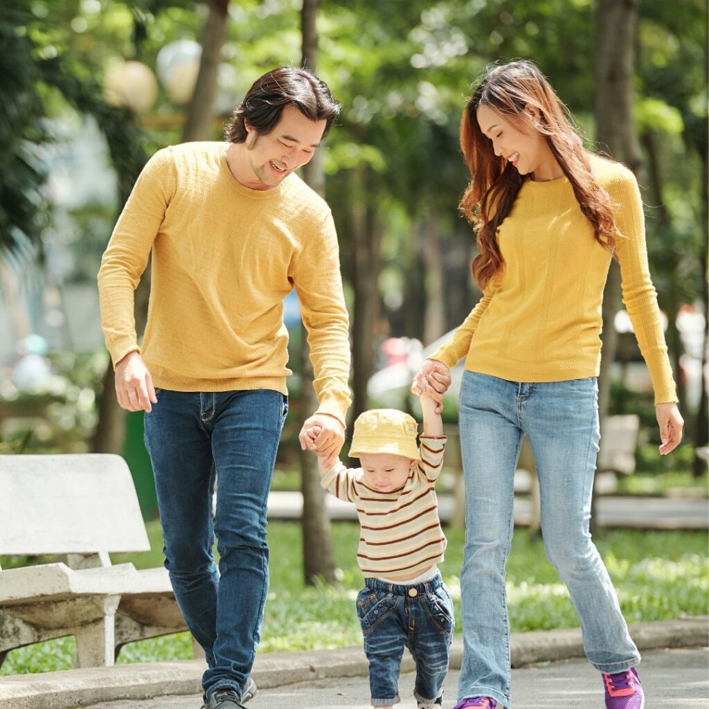 Young parents walking with toddler