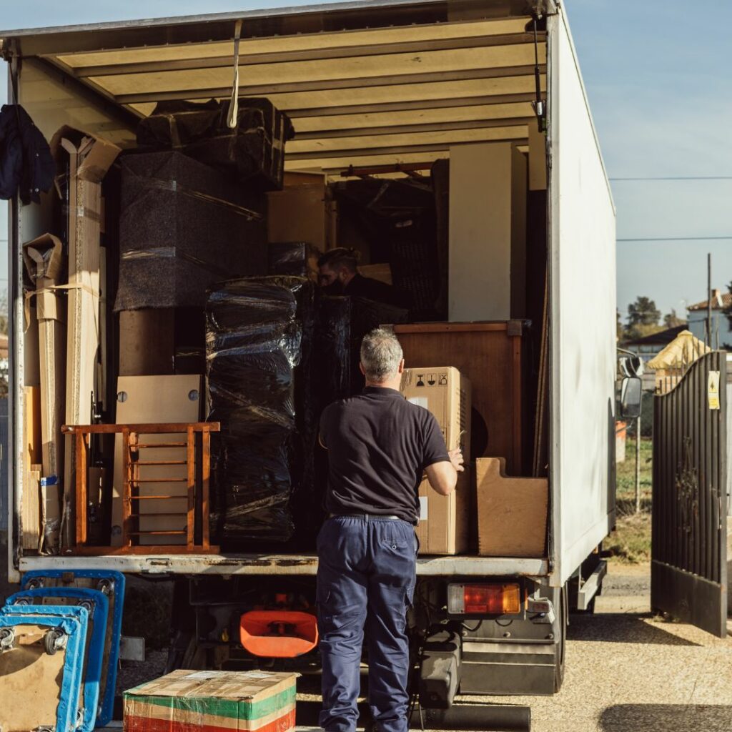 Man taking boxes out of moving truck