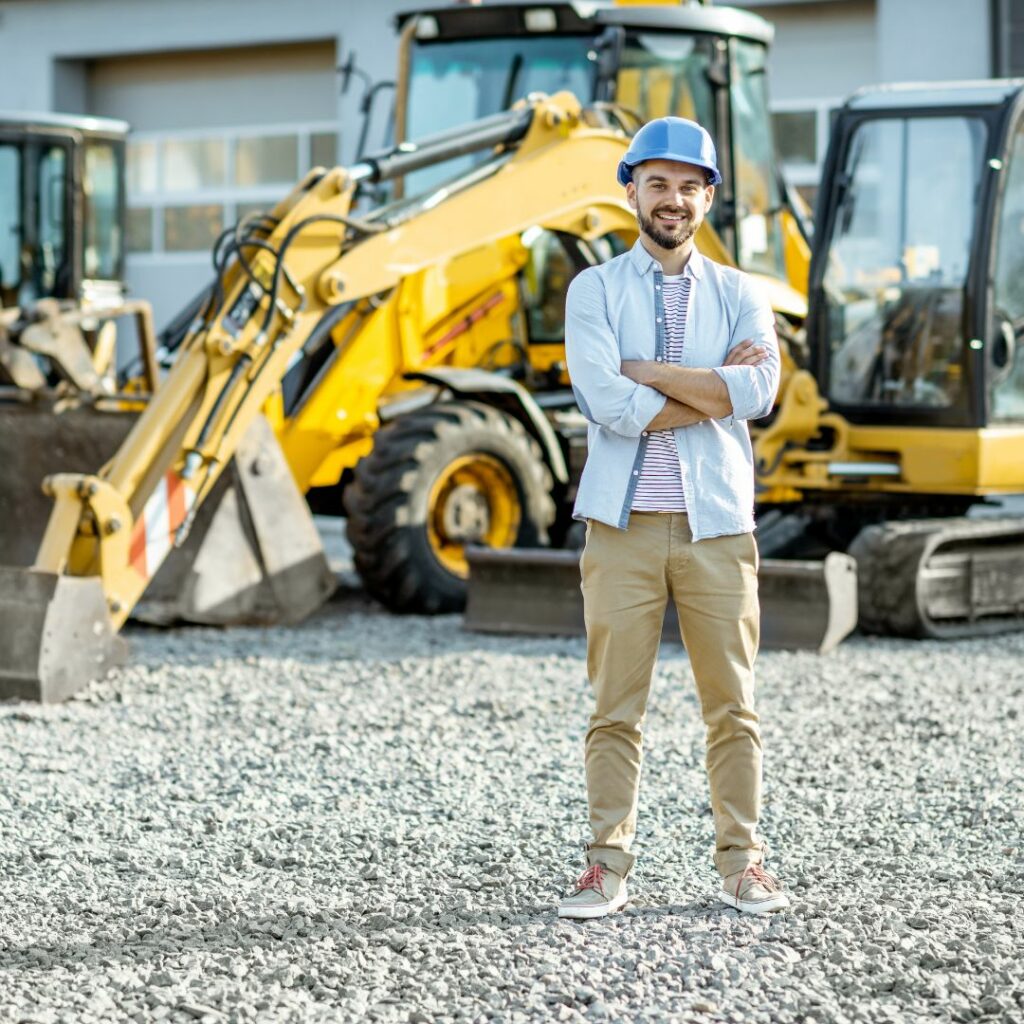 man in front of heavy machinery