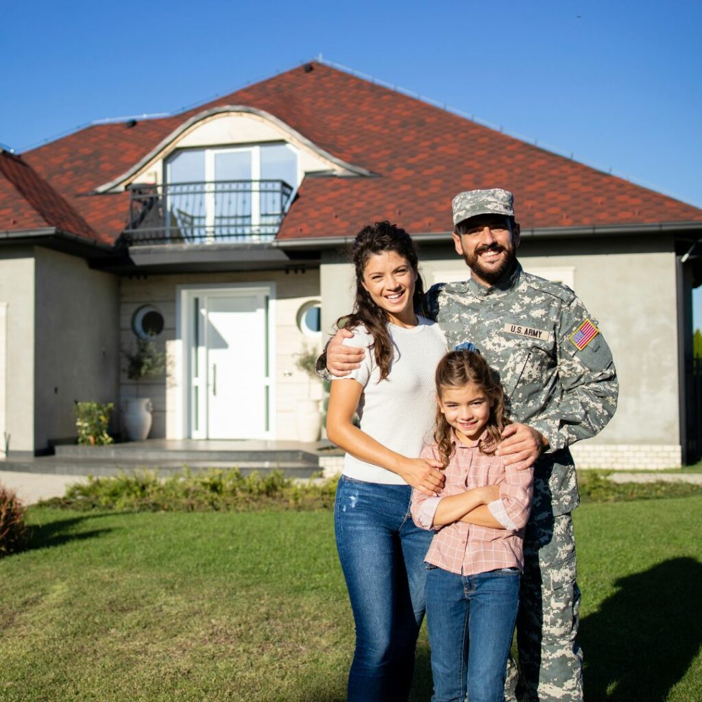 military family in front of new home